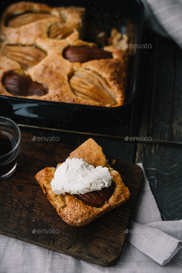 Fall french pear cake in a black ceramic bakeware - Stock Photo - Images