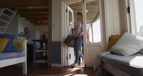 Happy cacusia mature couple coming with suitcases to hotel room alt