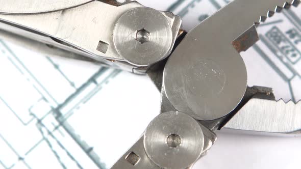 Metal Round-nose Pliers on Building Plan, Scheme, Rotation, Close Up, Macro alt