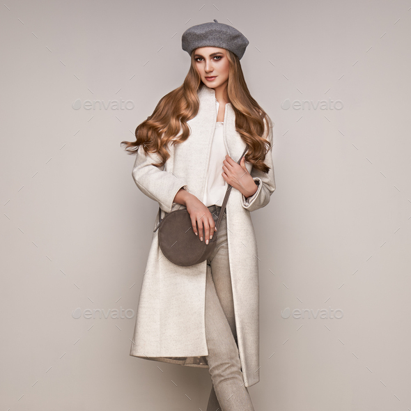 Young woman in white autumn coat - Stock Photo - Images