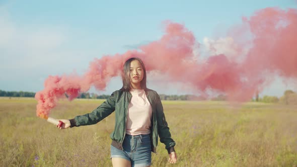 Asian Pretty Woman with Red Smoke Bomb in Nature alt