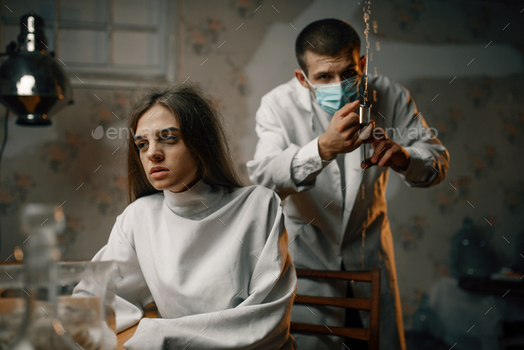 Psychiatrist preparing to give sedative injection - Stock Photo - Images