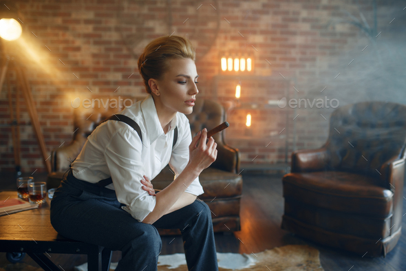 Woman in strict clothes sitting on the table - Stock Photo - Images