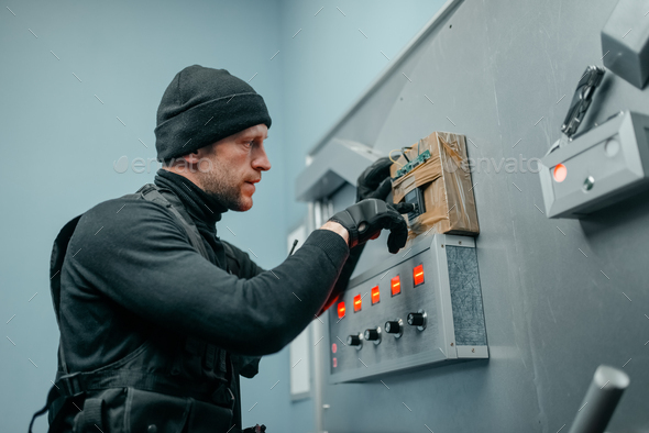 Robber in uniform trying to mines the vault door