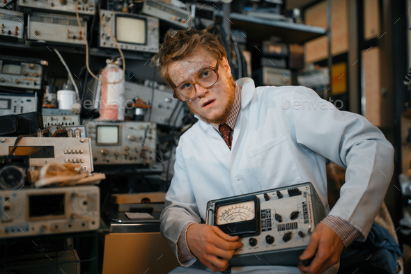 Crazy scientist holds electrical device in lab