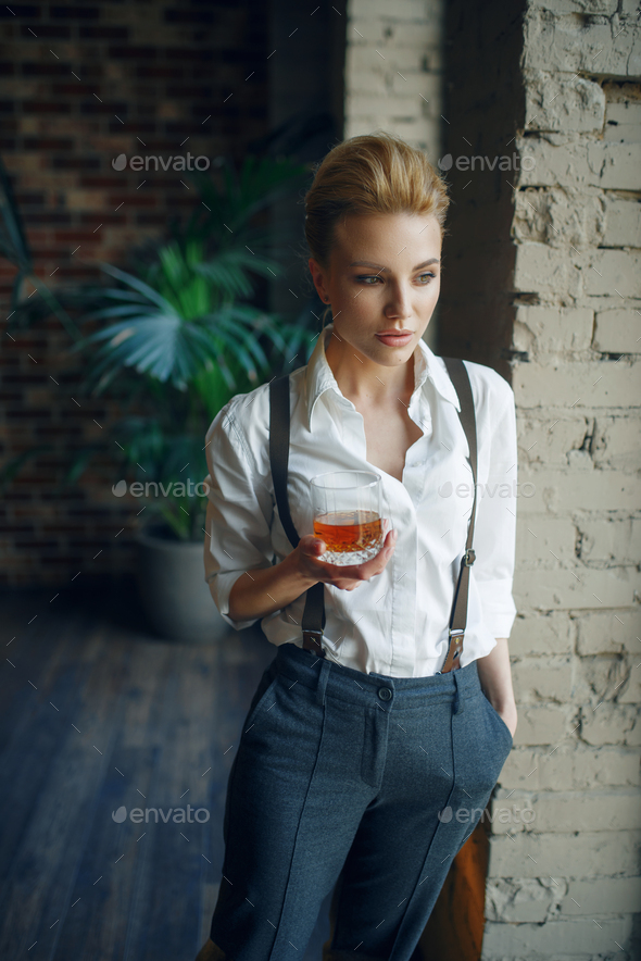 Woman holding glass of whiskey, retro fashion - Stock Photo - Images