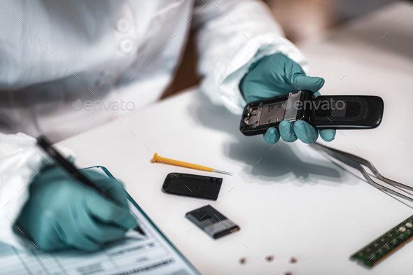 Forensics. Police Expert Examining Confiscated Mobile phone