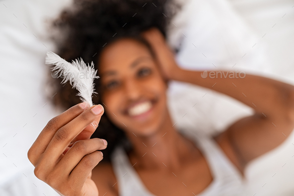 White soft feather in girl hand - Stock Photo - Images