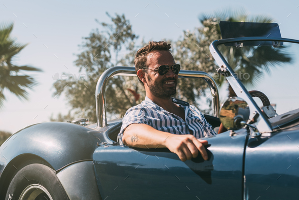 Man driving a convertible vintage car Stock Photo by davidpradoperucha