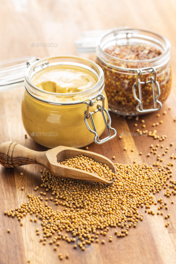 Mustard seed and yellow mustard and whole grain mustard. Stock Photo by