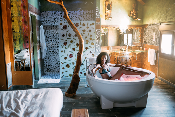 Young woman relaxing in the hydro massage bath