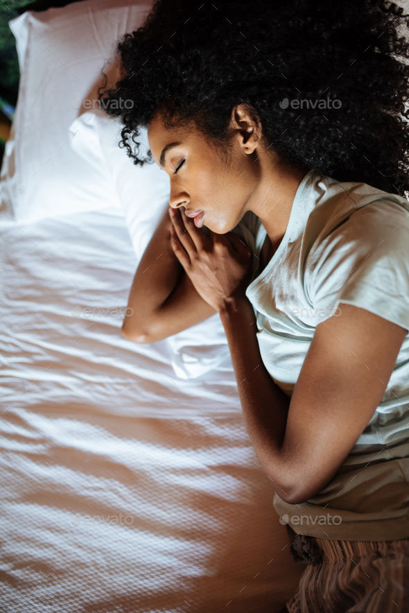 Beautiful black woman sleeping in bed