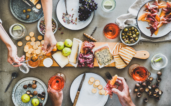 Mid-summer picnic with rose wine, cheese, charcuterie and appetizers - Stock Photo - Images
