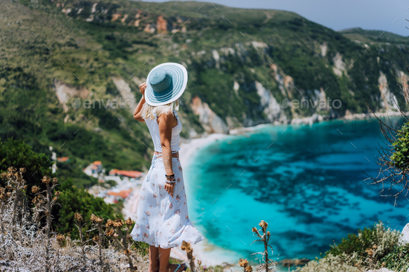 Young woman on Petani beach Kefalonia, admiring highly excited picturesque panorama of emerald blue - Stock Photo - Images
