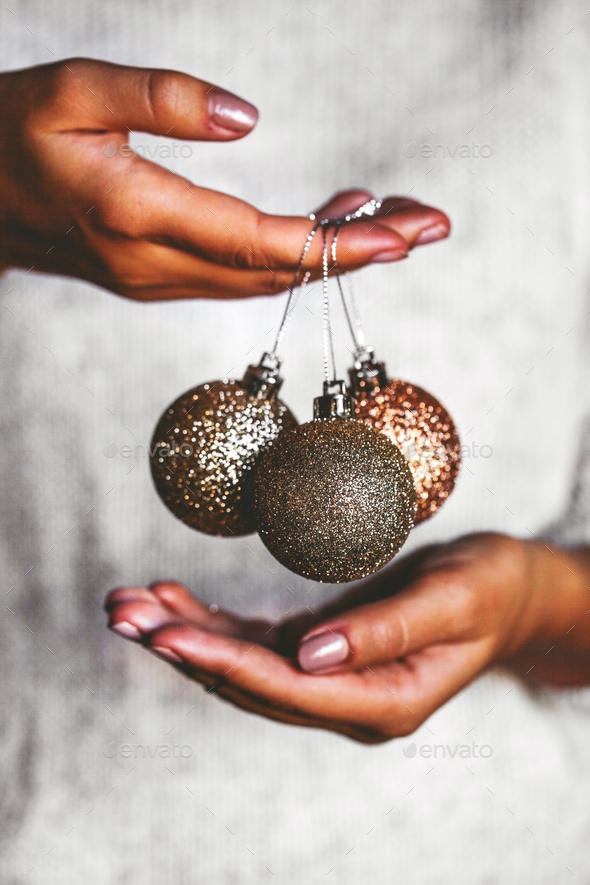 Woman in warm sweater holding toys glass decorative balls in hands, copy space. Christmas - Stock Photo - Images