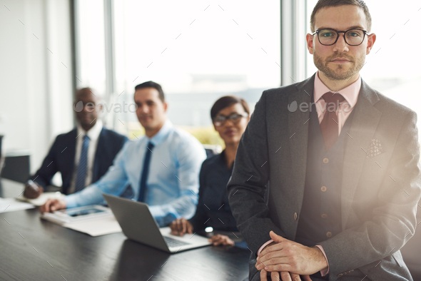Handsome Caucasian executive with three employees - Stock Photo - Images