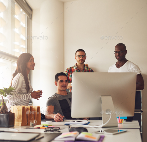 Group of young adults at small business - Stock Photo - Images