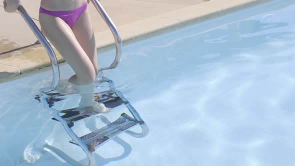 Attractive woman going into swimming pool