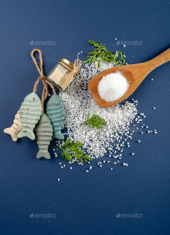 Fine and coarse salt with decor on a dark blue background. - Stock Photo - Images