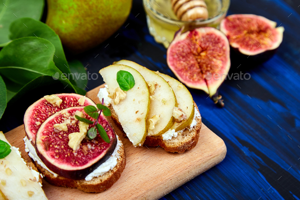 Bruschetta and Crostini with pear, ricotta cheese, honey, figs. - Stock Photo - Images