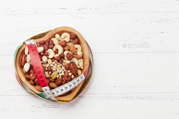 Various nuts selection on wooden table - Stock Photo - Images