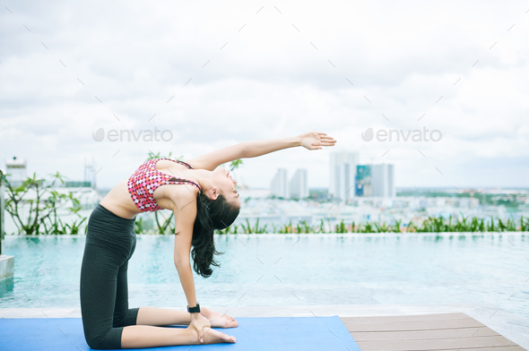 Asian fit woman exercising at the poolside - Stock Photo - Images