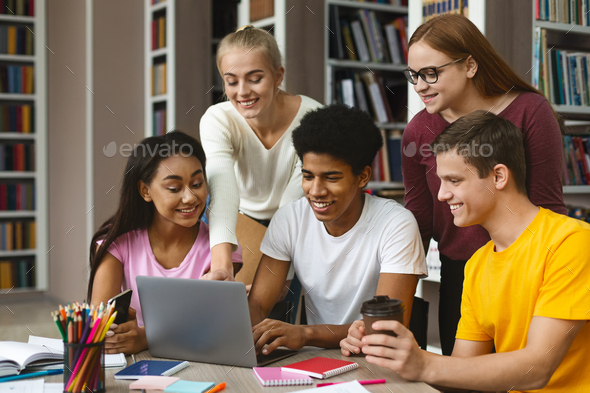 Group of international classmates checking on new project - Stock Photo - Images