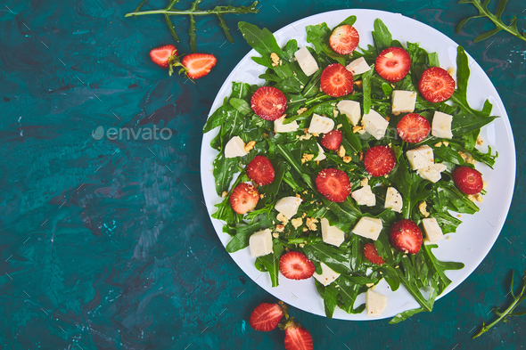 Fresh salad with arugula, strawberries, feta cheese and nuts. - Stock Photo - Images