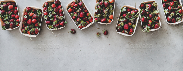Fresh strawberries in plastic-free boxes over grey background, wide composition - Stock Photo - Images