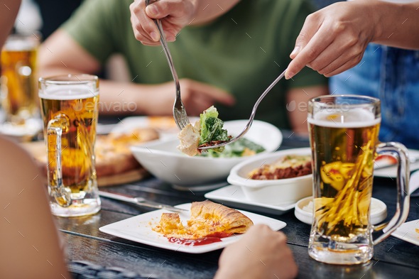 People eating food at the table - Stock Photo - Images