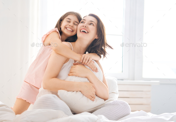 girl and her mother enjoying sunny morning - Stock Photo - Images