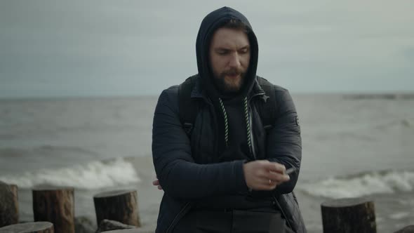 Man Smokes on the Seashore