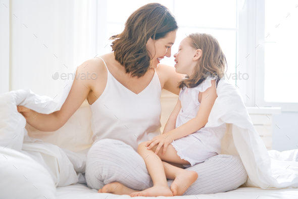 girl and her mother enjoying sunny morning - Stock Photo - Images