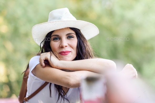 Woman with backpack standing on rural bridge - Stock Photo - Images