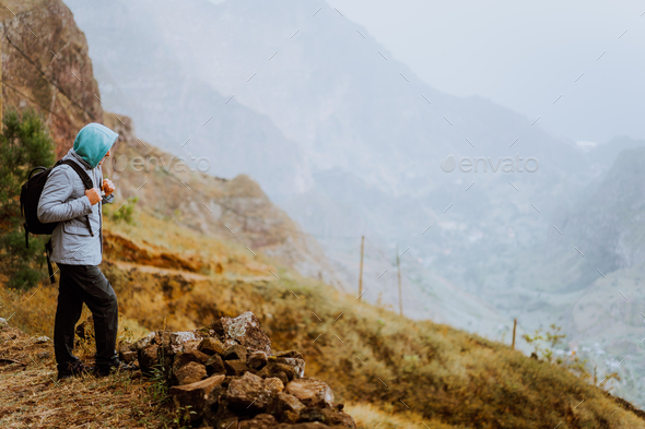 Male hiker looking down to Xo-Xo Valley. Santo Antao Island, Cape Verde. Traveler on mountains cliff - Stock Photo - Images