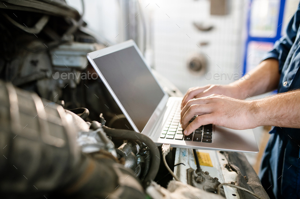Hands of young contemporary worker of technical service over laptop keypad - Stock Photo - Images