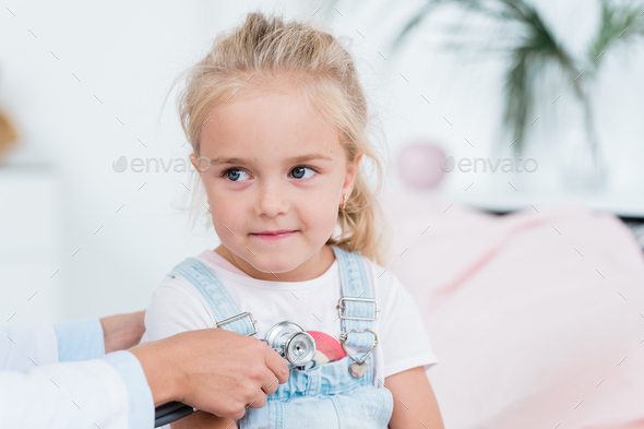 Cute Little Girl With Blond Hair Looking At Doctor Using