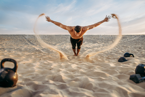 Push-up exercises in desert, flying sand effect - Stock Photo - Images