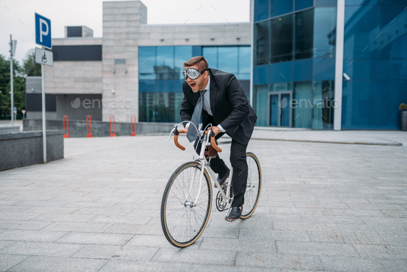 One businessman in funny glasses poses on bicycle - Stock Photo - Images