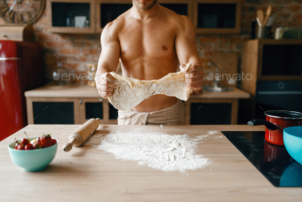 Athletic husband in underwear cooking on kitchen - Stock Photo - Images