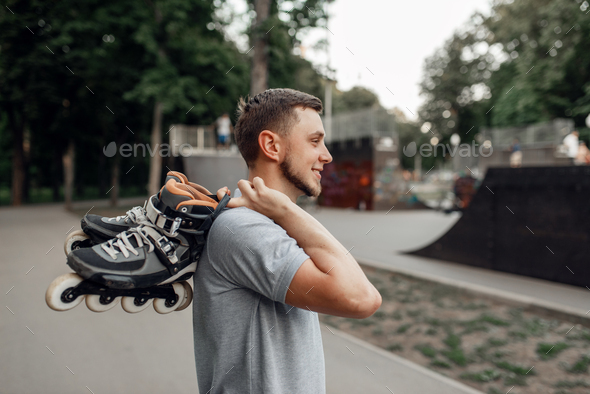 Roller skating, skater carries skates on shoulder - Stock Photo - Images