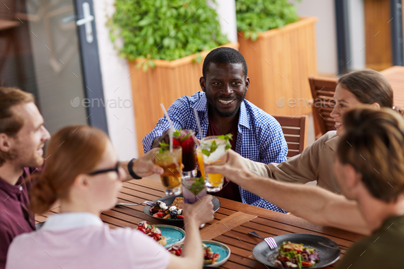Friends Enjoying Cocktails in Cafe - Stock Photo - Images