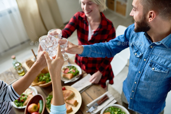 Friends Clinking Glasses at Thanksgiving Dinner - Stock Photo - Images