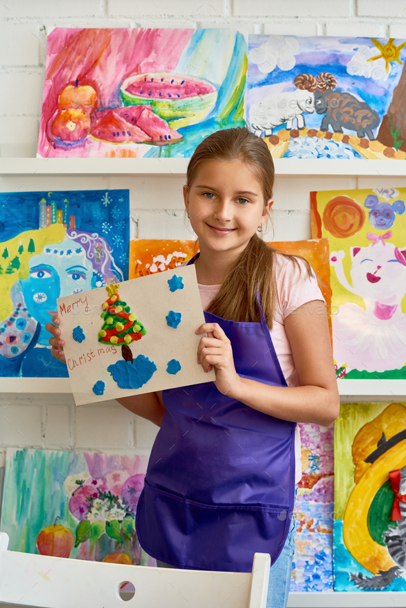 Happy Girl Posing with Christmas Picture - Stock Photo - Images