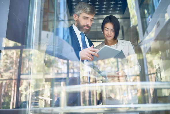 Analyzing Financial Figures with Colleague - Stock Photo - Images
