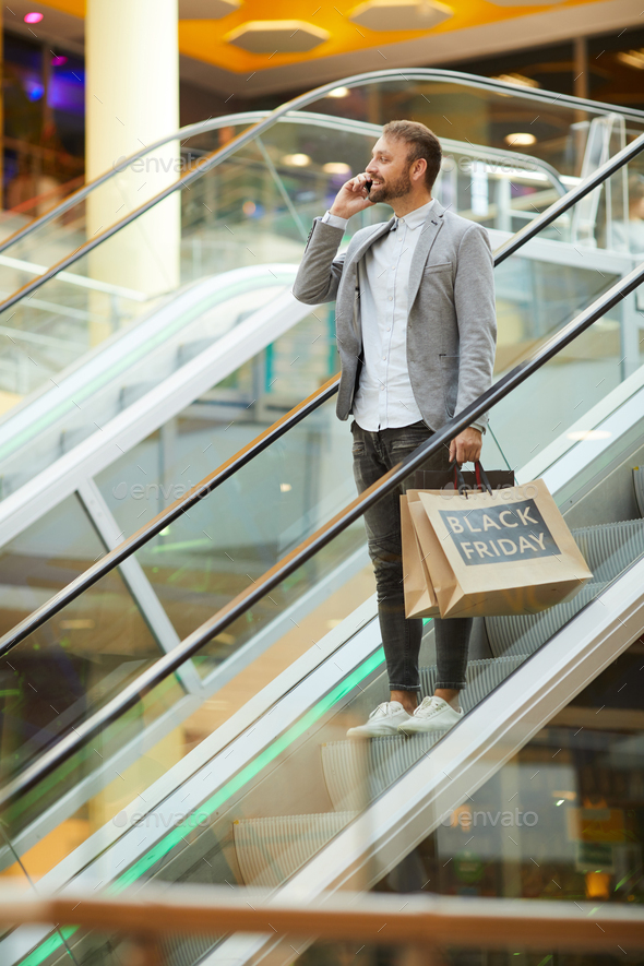 Handsome Man Speaking by Phone while Shopping - Stock Photo - Images
