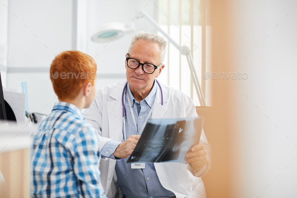 Doctor Explaining X-Ray to Little Boy - Stock Photo - Images