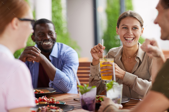 Cheerful Friends Enjoying Lunch Together - Stock Photo - Images