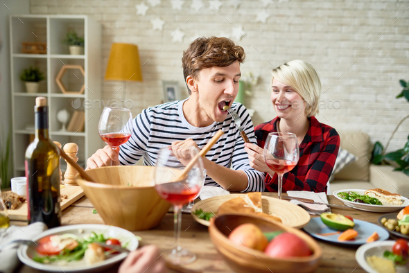Happy Young Couple at Festive Dinner Table - Stock Photo - Images