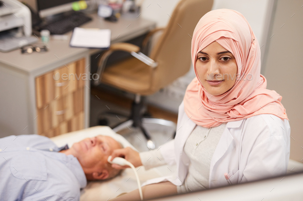 Arab Female Nurse Examining Patient - Stock Photo - Images
